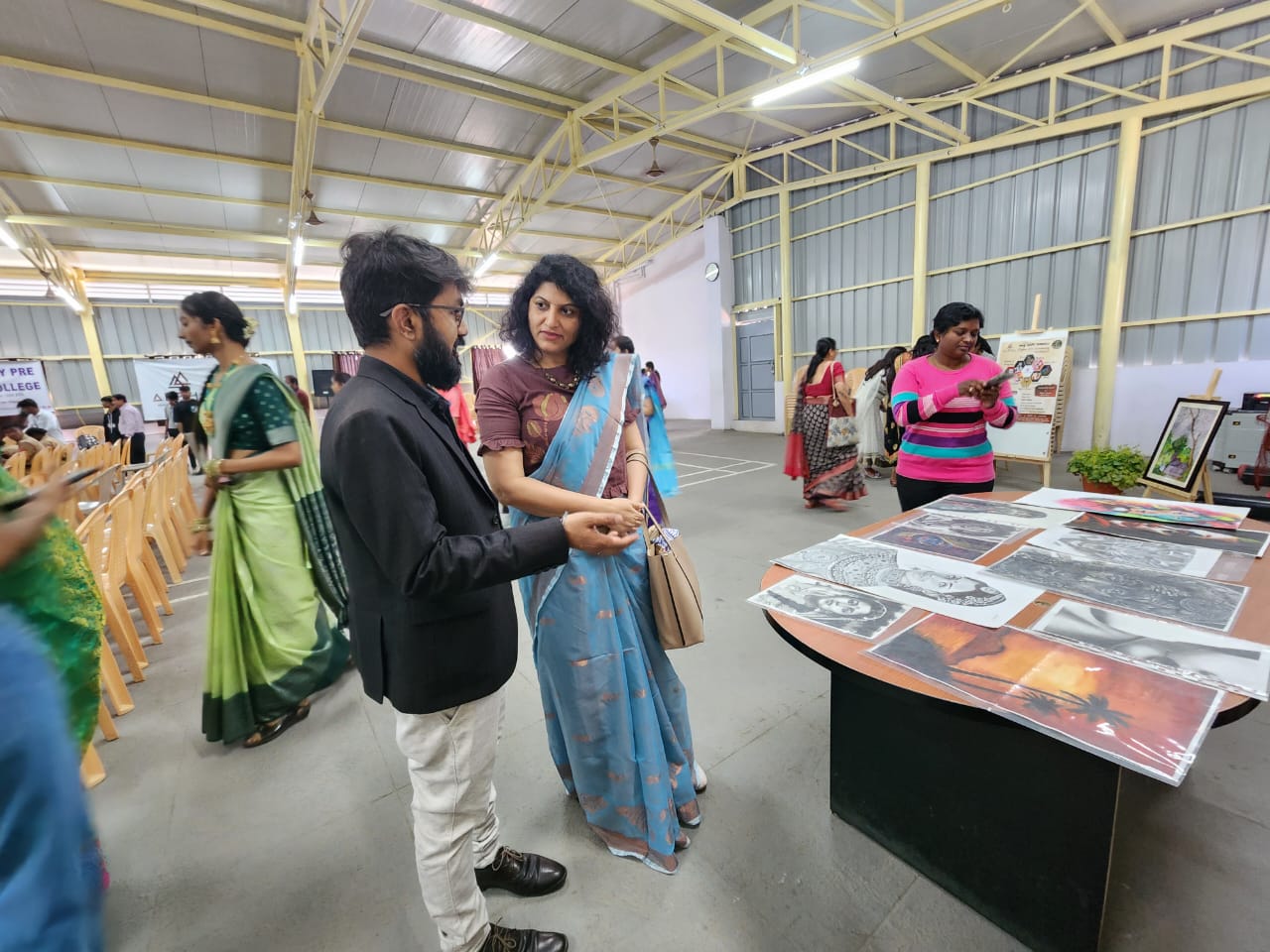 Women artists presenting their creative works at exhibition
