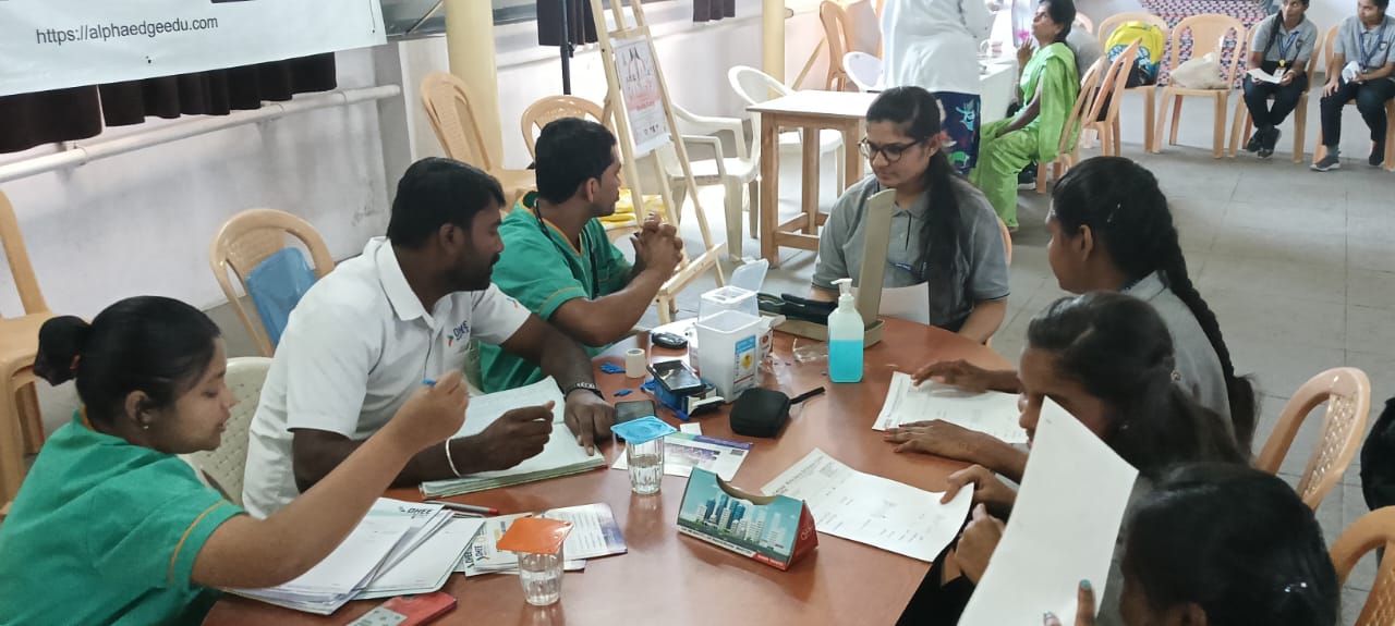 Women undergoing basic health assessment at outreach program