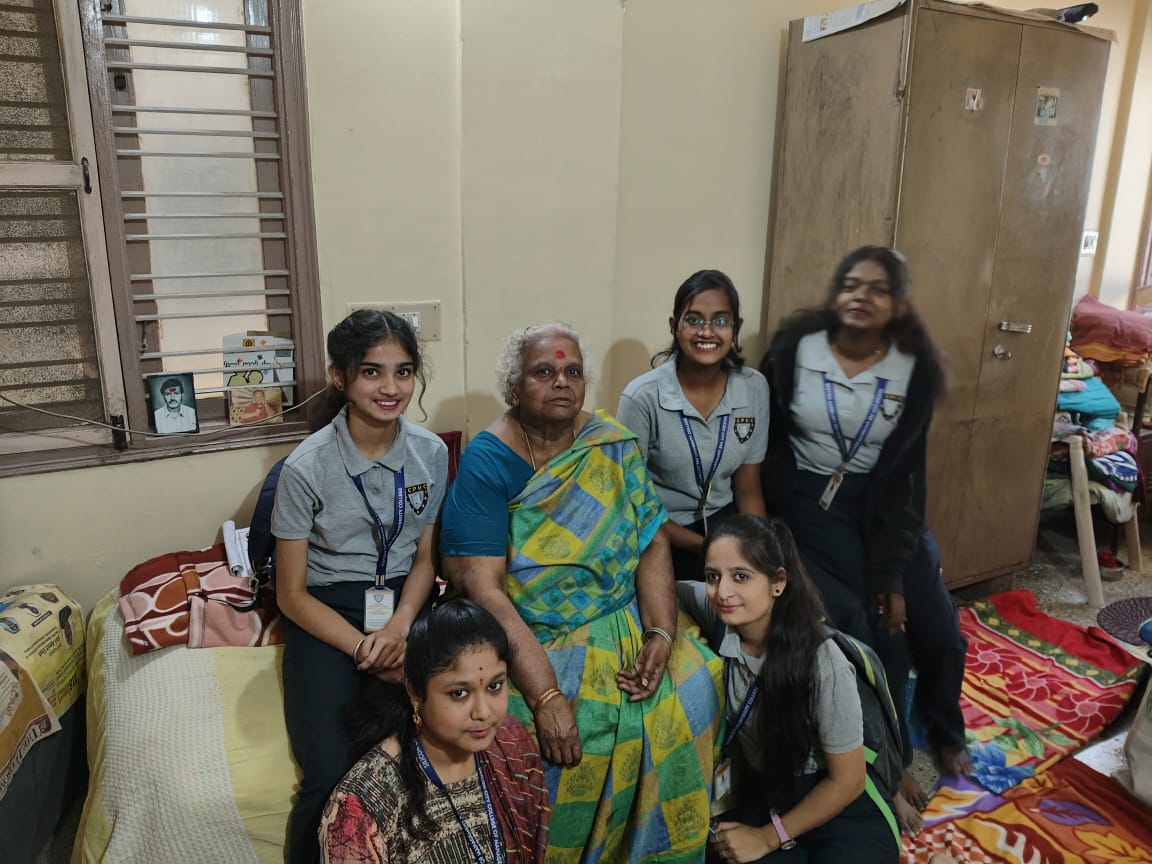 Participants interacting with senior citizens during outreach program