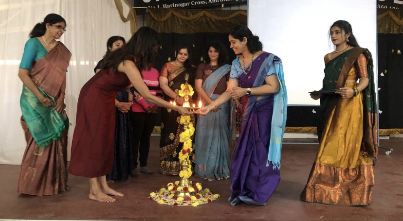 Women achievers receiving public acknowledgment on stage